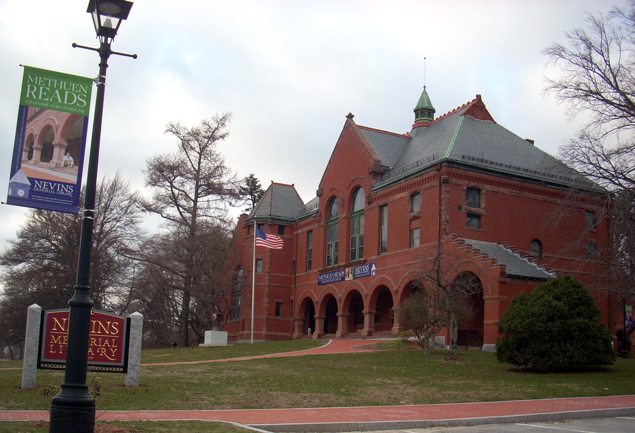The brick exterior and tower of Nevins Memorial Library in Methuen